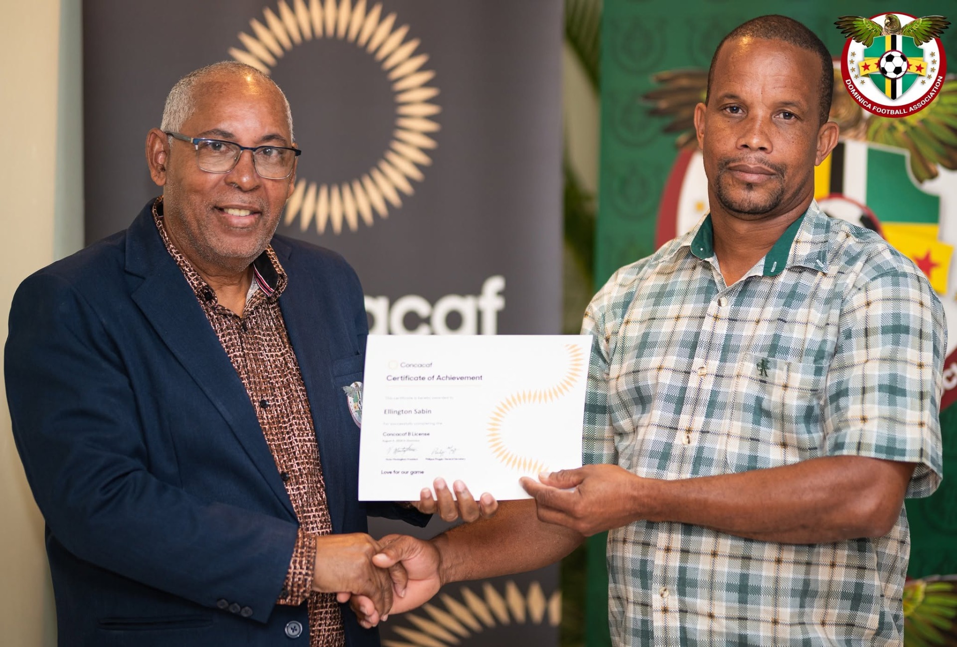 Ellington Sabin receiving his CONCACAF B License Certificate from President of the DFA Glen Etienne